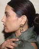 Gold domed jhumka earrings with Navratna gemstones, uncut polki diamonds, red enamel detailing, and cultured pearl fringes