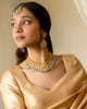 Apara polki bridal necklace with emeralds and pearls worn by a model