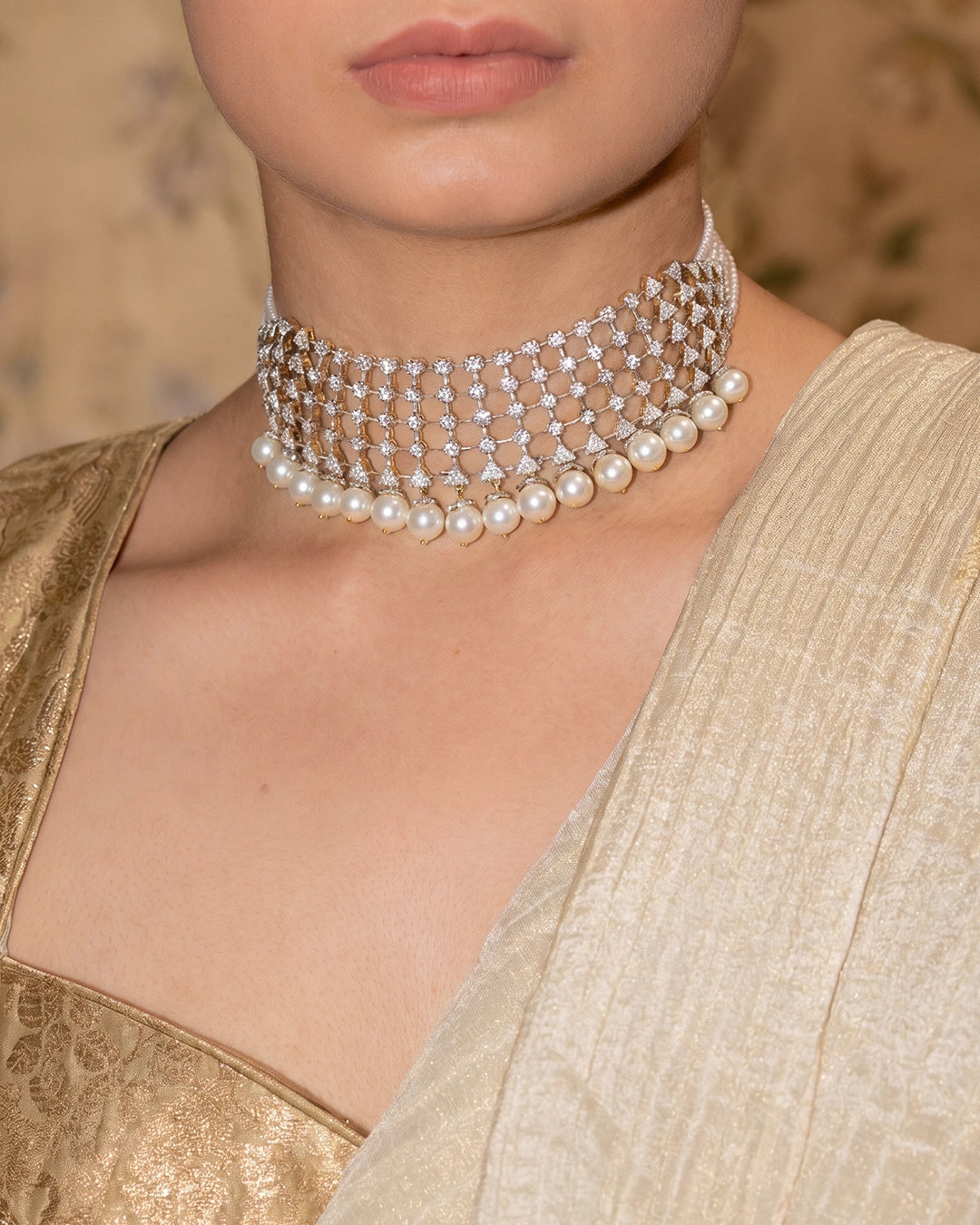 Model wearing the Aurus Jewels Damas Necklace - a gold diamond lattice choker with cultured pearl drops, styled close to the neckline for bridal and occasion wear.