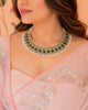 Model wearing the Aurus Jewels Esmer Necklace - a gold necklace with emerald cabochon and diamond halo motifs and a cultured pearl fringe, styled as an elegant statement neckpiece