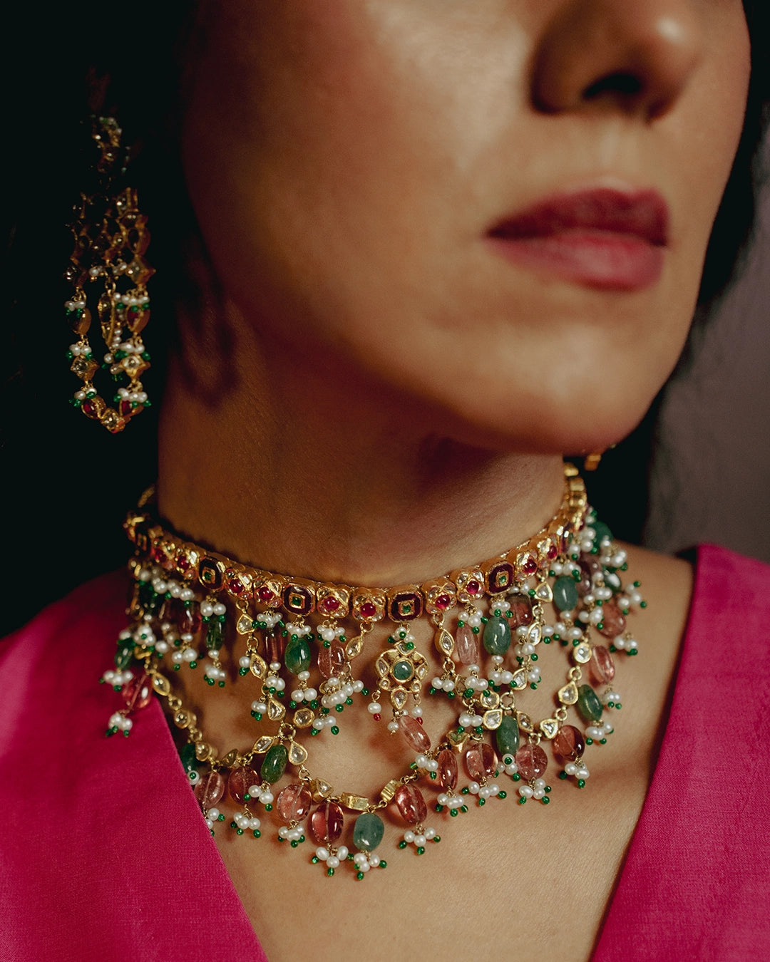 Gold Kaivi Necklace with kundan-set uncut diamonds, rubies, emeralds, pearls, green enamel accents, and cascading seed pearls and tourmaline beads for women.