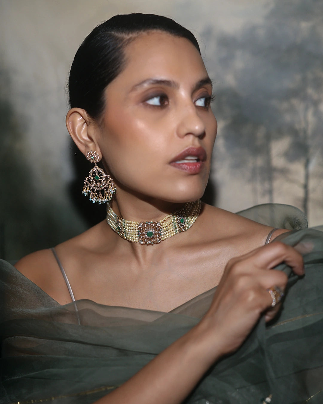 Keira gold choker necklace featuring cultured pearls, natural brilliant-cut and rose-cut diamonds, and a faceted emerald centre, handcrafted using traditional Hyderabadi jewellery techniques.
