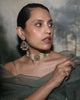 Keira gold choker necklace featuring cultured pearls, natural brilliant-cut and rose-cut diamonds, and a faceted emerald centre, handcrafted using traditional Hyderabadi jewellery techniques.