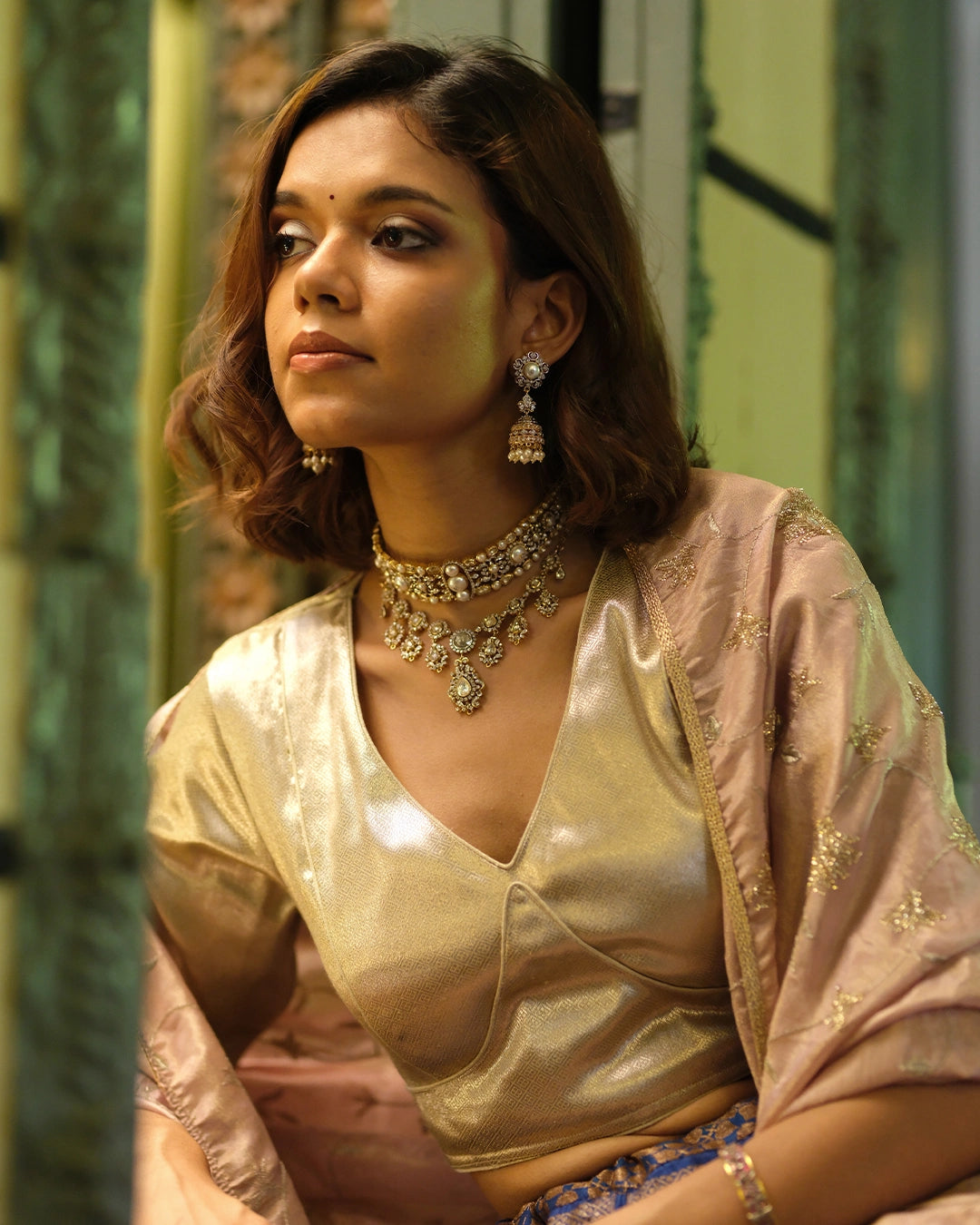 Model wearing the Aurus Jewels Naaz Necklace in 18k gold, styled at the neckline - a handcrafted diamond necklace with rose-cut diamond drops and brilliant-cut halo motifs.