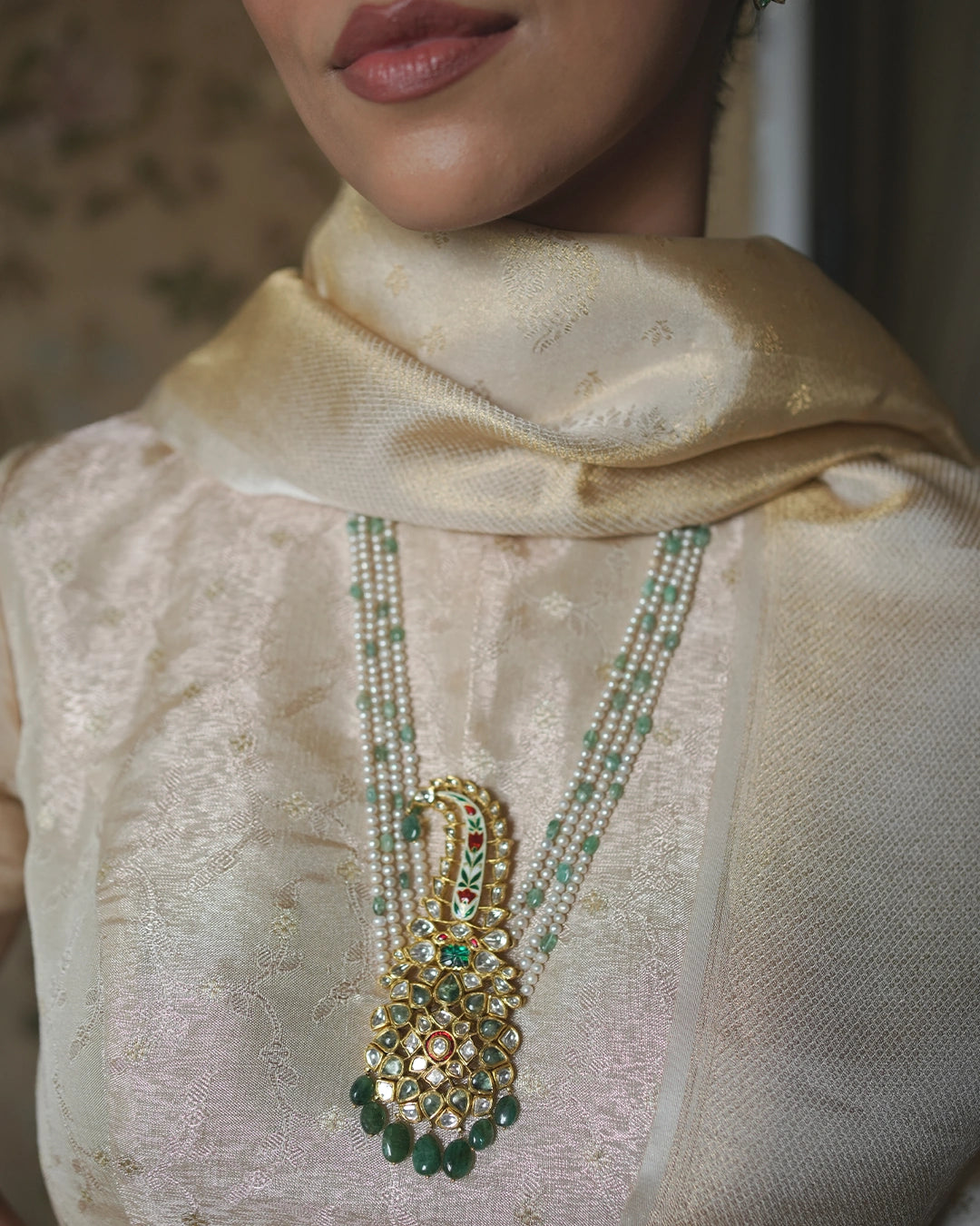 Model wearing the Nawaz polki and emerald bridal necklace with pearls