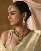 Rati gold polki necklace with uncut diamonds, wine-hued tourmaline drops, cultured pearls, green enamel accents, and intricate red meena work in a statement bridal jewellery design.