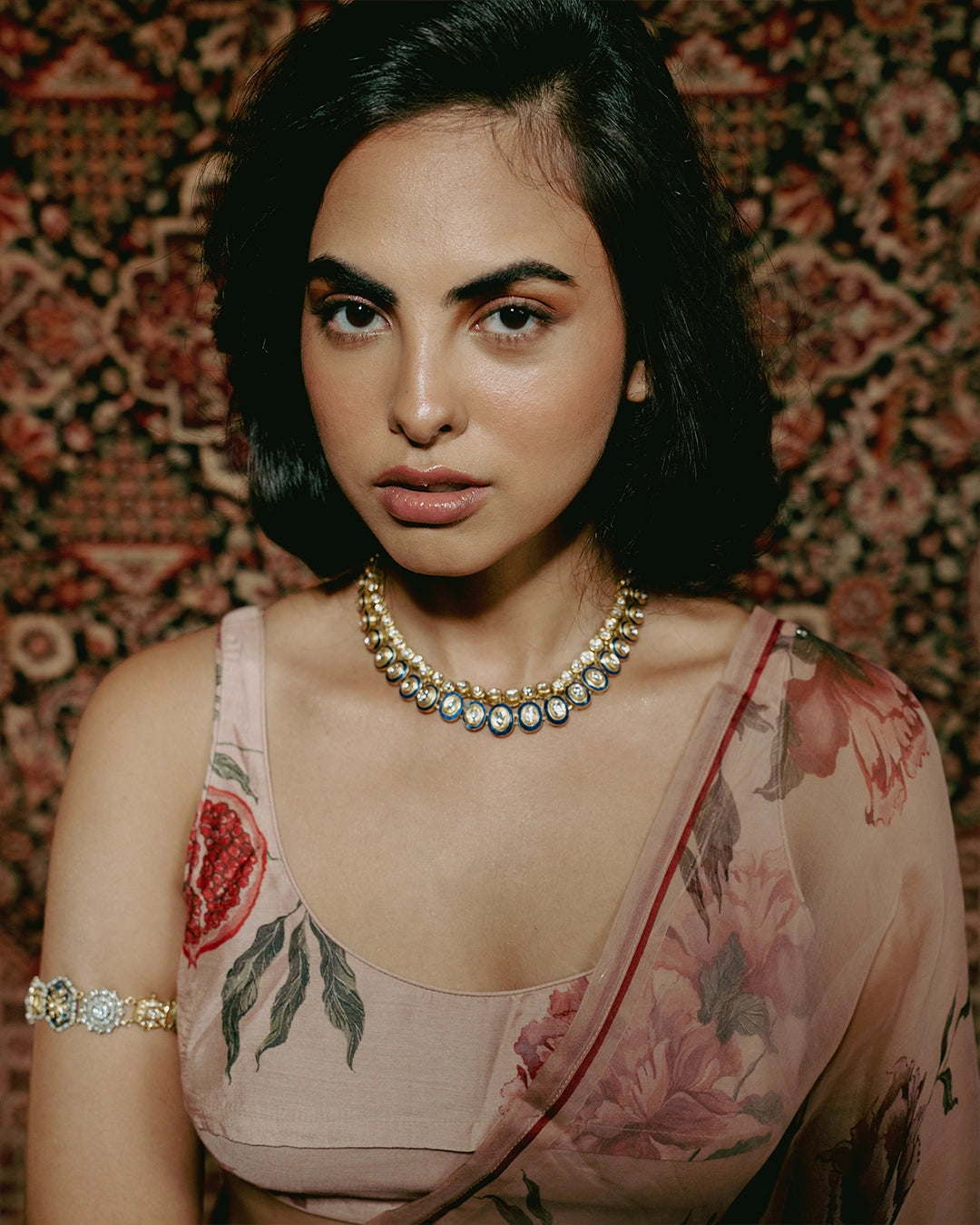 Gold Vaayu Necklace with polki-set units, navy blue enamel borders, and alternating round and oval motifs.