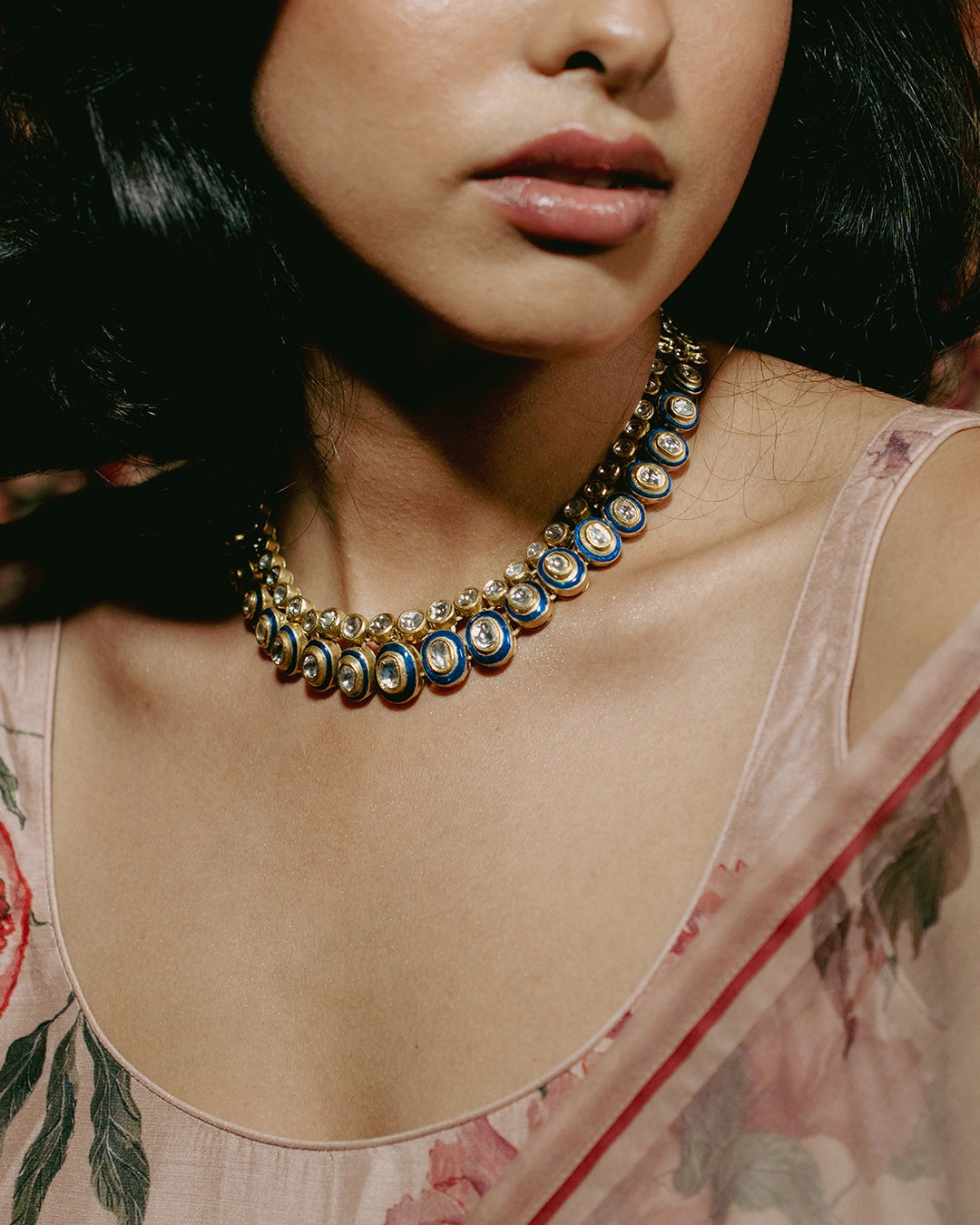 Gold Vaayu Necklace with polki-set units, navy blue enamel borders, and alternating round and oval motifs.