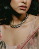 Gold Vaayu Necklace with polki-set units, navy blue enamel borders, and alternating round and oval motifs.