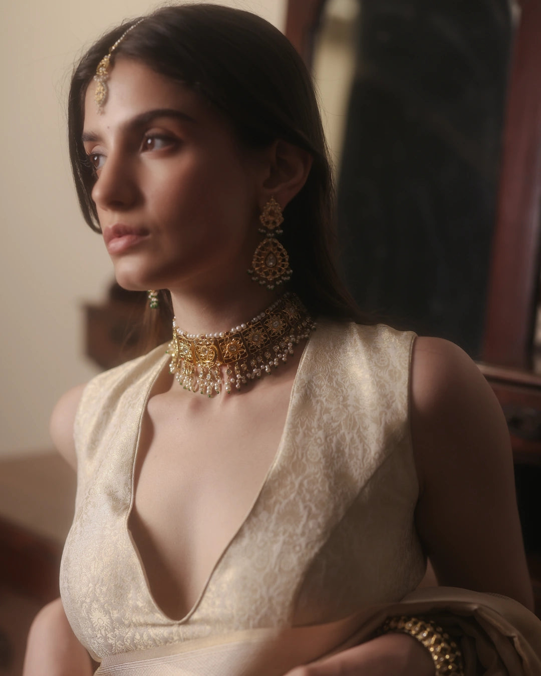 Handcrafted Indian gold bridal choker inspired by the traditional Guluband, featuring a central crescent moon (chaand) and floral (phool) motif with eight square units. Adorned with polki diamonds, kundan-set stones, pearl borders, and pearl-and-polki drop strands, this heirloom bridal necklace blends traditional craftsmanship with timeless elegance.