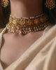 Handcrafted Indian gold bridal choker inspired by the traditional Guluband, featuring a central crescent moon (chaand) and floral (phool) motif with eight square units. Adorned with polki diamonds, kundan-set stones, pearl borders, and pearl-and-polki drop strands, this heirloom bridal necklace blends traditional craftsmanship with timeless elegance.